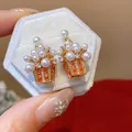 Detailed macro shot of 18K gold plated zircon pearl basket earrings in gift box - Popcorn Bucket Design / Gold & White (Silver Earring Post, Real Gold Plated)