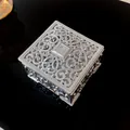 Detailed view of a vintage silver jewelry box with ornate filigree design on black background. - Square / Silver