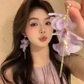 Close-up of elegant long purple petal tassel earrings with gold finish worn by a model - 8# 925 Sterling Silver Earring Post Style