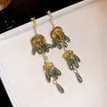 Detailed view of long gold tassel earrings with smoky grey teardrop beads and pearls - 16# 925 Sterling Silver Earring Post Style
