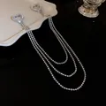 Vista dettagliata di un'elegante spilla di strass a forma di cuore con lunghe catene. - Stile con Pendaglio a Cuore / Argento