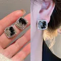 Detailed macro shot of elegant silver needle square zircon stud earrings for women - Black (No.14)