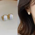 Elegant minimalist gold-tone stud earrings with white resin inlay and model wear view - White (No. 16)