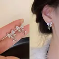 Elegant silver bow-knot earrings with sparkling zircon crystals shown in high detail - Silver Tassel (Style 36)