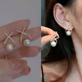 Elegant white pearl stud earrings with a crystal X-shaped setting in a golden finish. - Gold & White Pearl (Style 40)