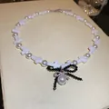Elegant vintage faux pearl necklace with white crosses and a black beaded bow pendant - Black Bow Pearl Style (65#)