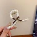 Elegant Korean style shark hair claw clip with white beads and a brown ribbon bow - 25# Claw Clip - Off-white - Medium Cross - Heart Bow