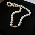 Elegant vintage-style white faux pearl necklace with a silver-toned metal clasp. - Single Layer Pearl Insert Clasp (74#)