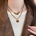 Close-up detail of a vintage double-layered cord necklace featuring polished tiger eye stones - Double Layer Design (1#) / Gold & Brown Double Layer