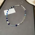 French vintage necklace featuring blue stones, faux pearls, and geometric silver accents. - Blue White Geometric Patchwork (125#)