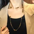 Vintage brown tiger eye stone sweater necklace with gold beads worn over a black top - Abacus Bead Gold Long Necklace (51#) / Gold Brown