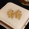 Detail view of irregular gold firework stud earrings set with sparkling zircons - Gold (925 Sterling Silver Earring Post)