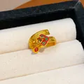 Detailed view of a gold-plated open ring featuring red enamel flower and lucky charms - Enamel Ruyi Cloud Pattern with Pendant (WR515) / Open Design / Gold-Red