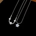 Macro view showing details of French zircon star pendant and pearl necklaces on black background - Star Pearl Style (Double Layer) / Silver
