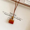 Detailed view of a vintage handbag pendant necklace with a natural wooden bead accent. - Nostalgic Red Handbag Shape Leather Necklace / 40# Necklace-Gold-Red