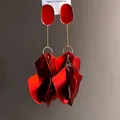 Detail view of retro red petal pendant earrings with gold-tone accents and oval studs - Red