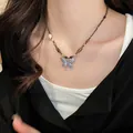 Close-up of vintage butterfly pendant necklace with tiger eye stone beads on a model. - Silver Butterfly Tiger Eye Clavicle Chain