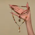Elegant triple-layer beaded necklace with red cord and gold pendants in vintage style - Triple Layer Retro Necklace