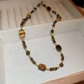 Detailed view of a retro Tiger's Eye beaded necklace presented in a soft beige jewelry tray - Retro Tiger Eye Rectangular Bead Chain