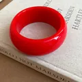 Detailed view of a vibrant red retro round bangle with a smooth and high-gloss finish - Round Wide Bangle / Red