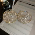 Vista detallada de pendientes de aro dorados brillantes con engaste de pedrería. - Aro Grande con Pavé Completo (43) / Dorado