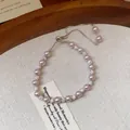 Close-up view of elegant French style pearl and zircon bracelet on textured background - Adjustable Drawstring / Pink