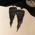 Detail of elegant black heart-shaped zircon tassel earrings for evening gowns. - Heart Tassel Style / Black