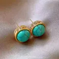 Close-up detail of gold-plated turquoise stud earrings with sparkling crystal accents - Gold-Blue Tassel