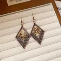 Macro detail of bohemian geometric earrings with vintage bronze finish and beads - 31# Antique Gold