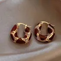 Detailed view of gold chunky hoop earrings featuring burgundy enamel and crystals. - 10# Gold-Red