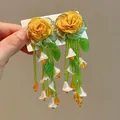 Macro close-up of handmade yellow rose floral earrings with green beaded long tassels - Nature Style Flower Tassel With Silver Post / Green