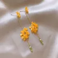 Detail showing yellow flower clusters and green bead accents on gold tassel earrings - 32# Yellow