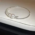 Detailed macro view of elegant Baroque pearl and pavé rhinestone open-ended bangle - Style 4
