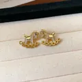 Close-up of 18k gold plated rocking horse stud earrings with sparkling pave zircons. - 1# Rocking Horse Style (HE28716) / Gold