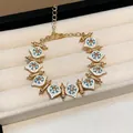 Elegant vintage gold-plated bracelet featuring white enamel details and sparkling rhinestones - Bracelet / Gold-Blue