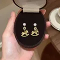 Luxury 18k gold-plated rocking horse stud earrings with white pearls and sparkling zircons - 23# Pearl Linked Rocking Horse Style (HE28716) / Gold