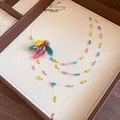 Macro detail of a handmade colorful beaded necklace with a central floral bead element. - Silver Multicolor