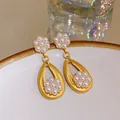 Close-up of French vintage floral pearl earrings with brushed gold texture - Flower Pearl Style (9#)
