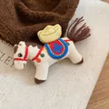 Primer plano de un broche de caballo de tela con bordado de lingotes de oro para regalos - Blanco (Estilo Lingote de Oro)