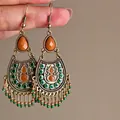 Close-up of bohemian vintage drop earrings with green and orange bead tassels - Hook Style / Bronze Gold-Orange Green