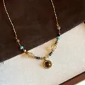 Close-up of a vintage tiger eye pendant necklace with colorful beads and woven cord. - Necklace (8#) / Gold