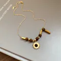 Close-up of the sun pendant and tiger eye beads on a gold chain necklace. - Sun Shape Style (13#) / Gold