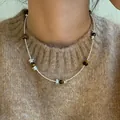 Detailed close-up of a women's tiger eye beaded necklace worn over a brown knit sweater - Necklace (3#) / Silver-Coffee