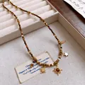 Elegant tiger eye beaded necklace featuring gold sun and star charms for a celestial look. - Necklace (60#) / Gold Brown