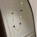 Detail view of a vintage gold chain necklace featuring tiger eye beads and gold beads. - Necklace (63#) / Gold Brown
