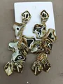 Statement glossy gold-tone petal drop earrings in a bohemian vacation style for women - Steel Pin Style / Gold