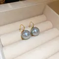 Detailed close-up of elegant grey pearl drop earrings with gold hooks in a box - Grey Pearl Ear Hook 13mm (Ear Hook)