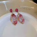 Elegant sweet pink and white marble pattern resin drop earrings with gold-toned metal edging - Irregular Geometric