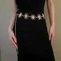 Detail view of a gold Bohemian sun-motif metal waist chain belt on a black dress - Vintage Sun Portrait Style (18#)
