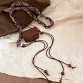 Detailed view of retro brown mini bag waist chain with paisley strap and wooden beads - Waist Chain Bag (HN10376) / Coffee